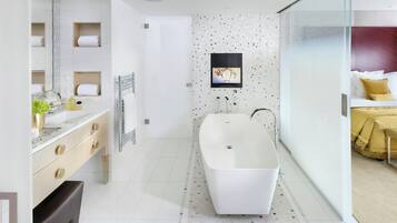 Deluxe Suite | Bathroom | Designer toiletries, hair dryer, bathrobes, slippers