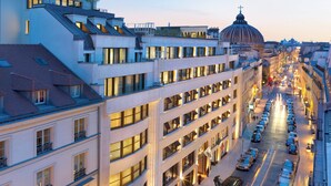 A multi-story hotel with a modern architectural design, featuring balconies and large windows. - Mandarin Oriental, Paris (Paris)