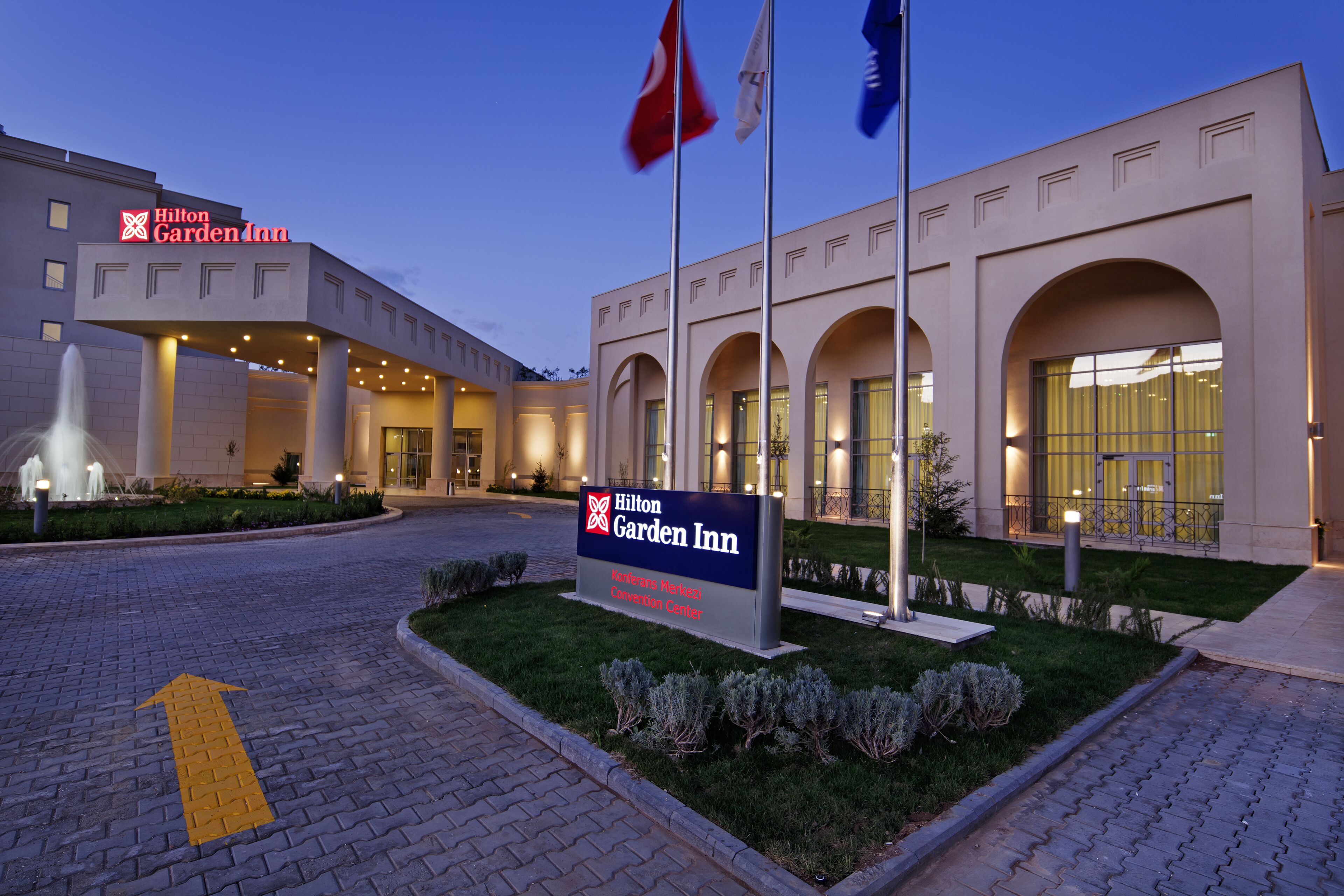 A Hilton Garden Inn with a sign indicating the location of the American Motorcoach Convention Center.