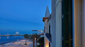 A coastal view with a building, a marina, and a clear sky. - Poseidonion Grand Hotel (Spetses)