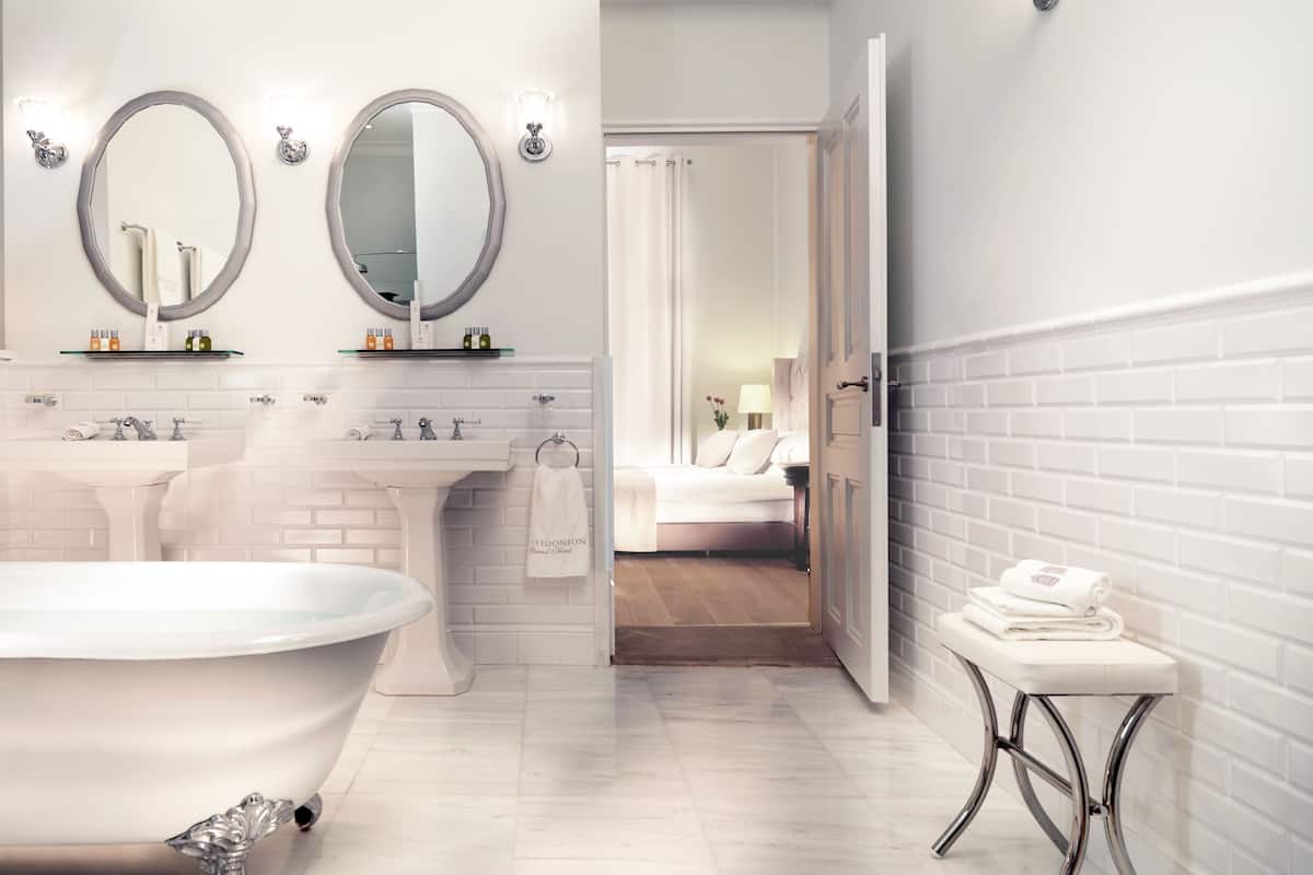 superior suite | bathroom | combined shower/bathtub, designer toiletries, hair dryer, bathrobes