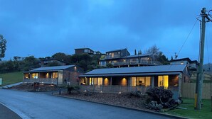 A two-story house with a balcony and a garage. - Driftwood Cottages (Dover)
