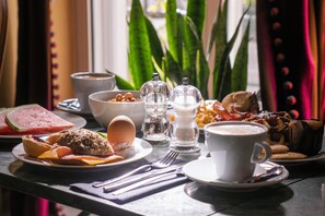 A breakfast table with various food items, utensils, and a cup of coffee. - Lisbon Art Stay Hotel & Apartments (Lisbon)