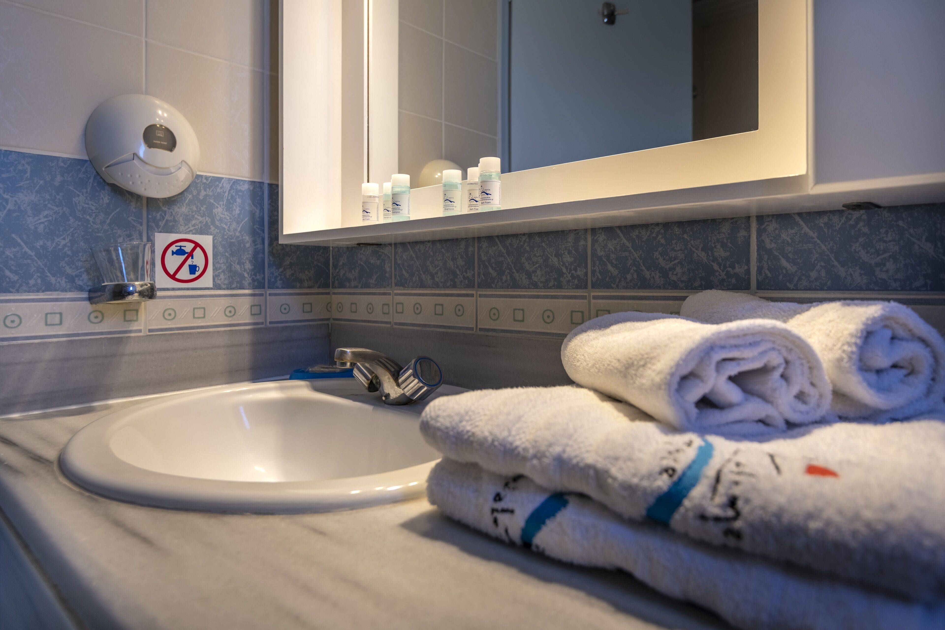 shower, hair dryer, slippers, towels