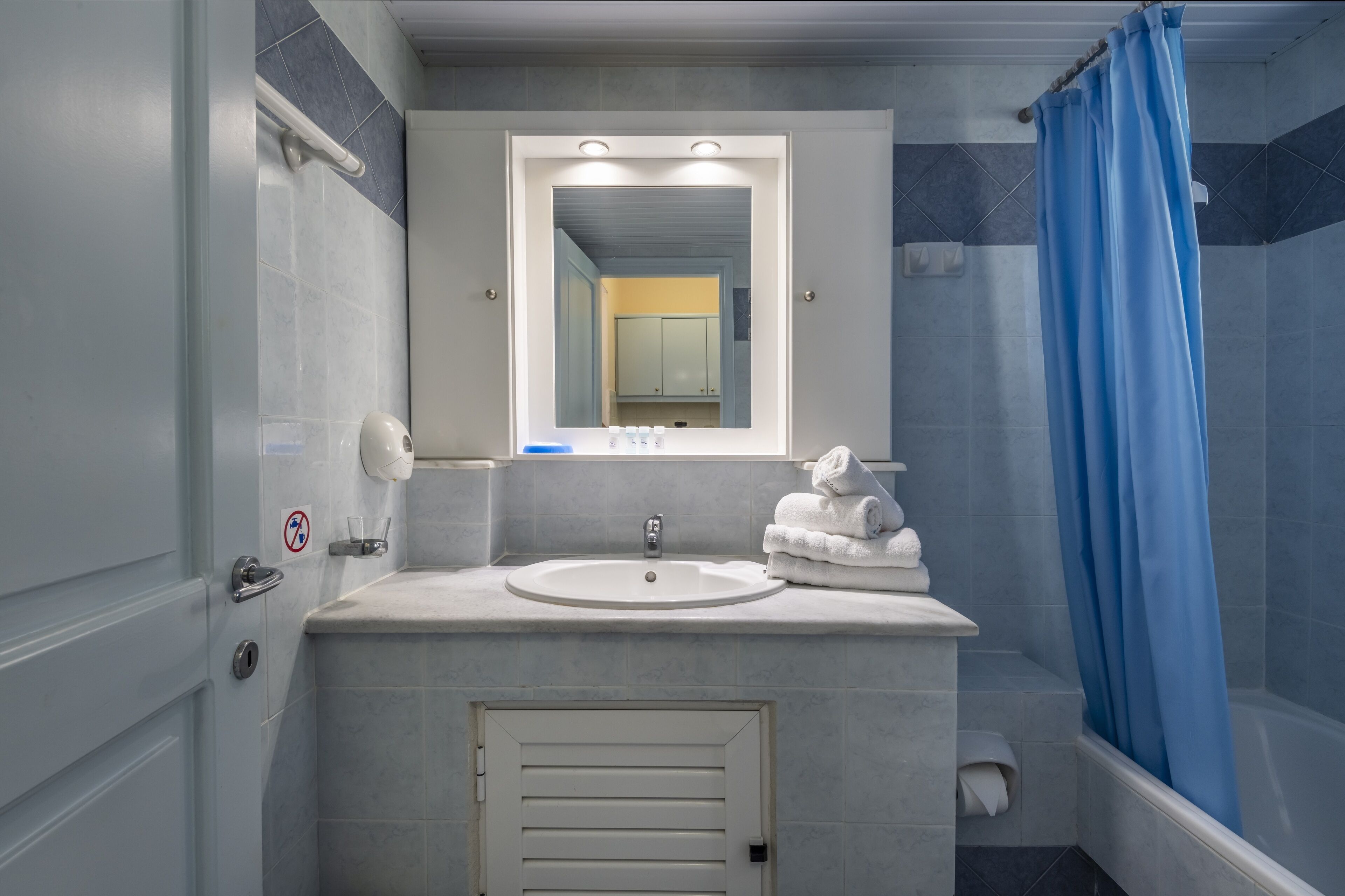 shower, hair dryer, slippers, towels