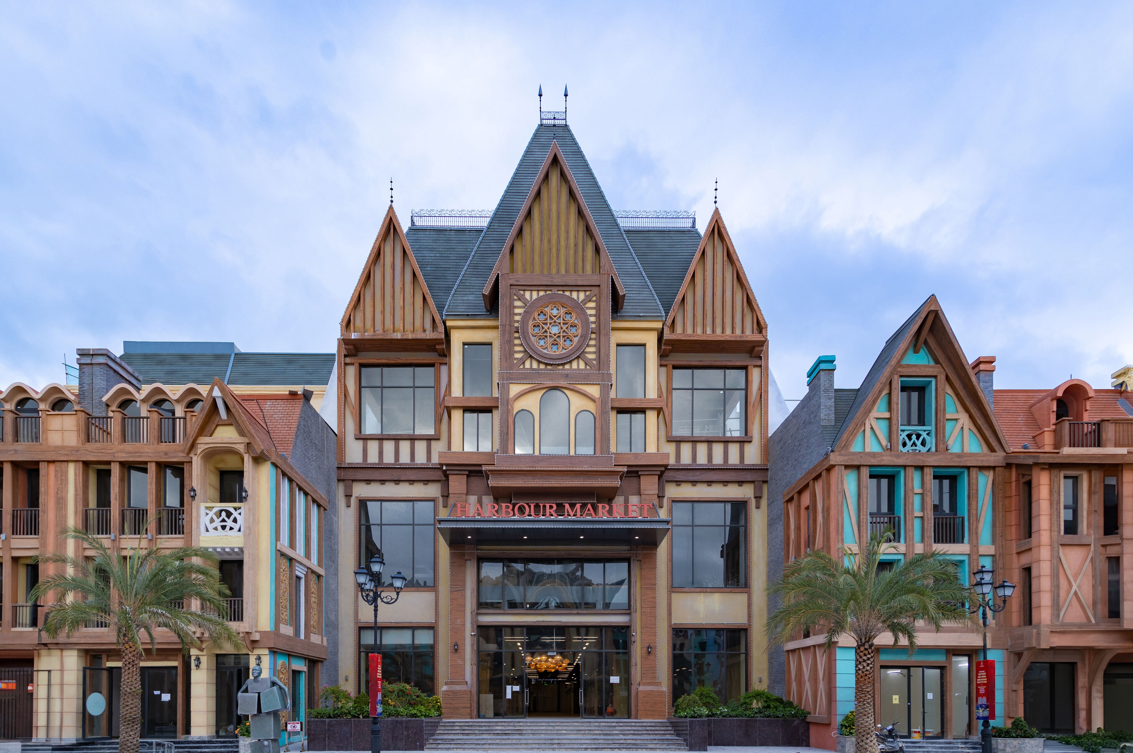 A multi-story building with a prominent 'Harbour Market' sign, large windows, and a central clock.