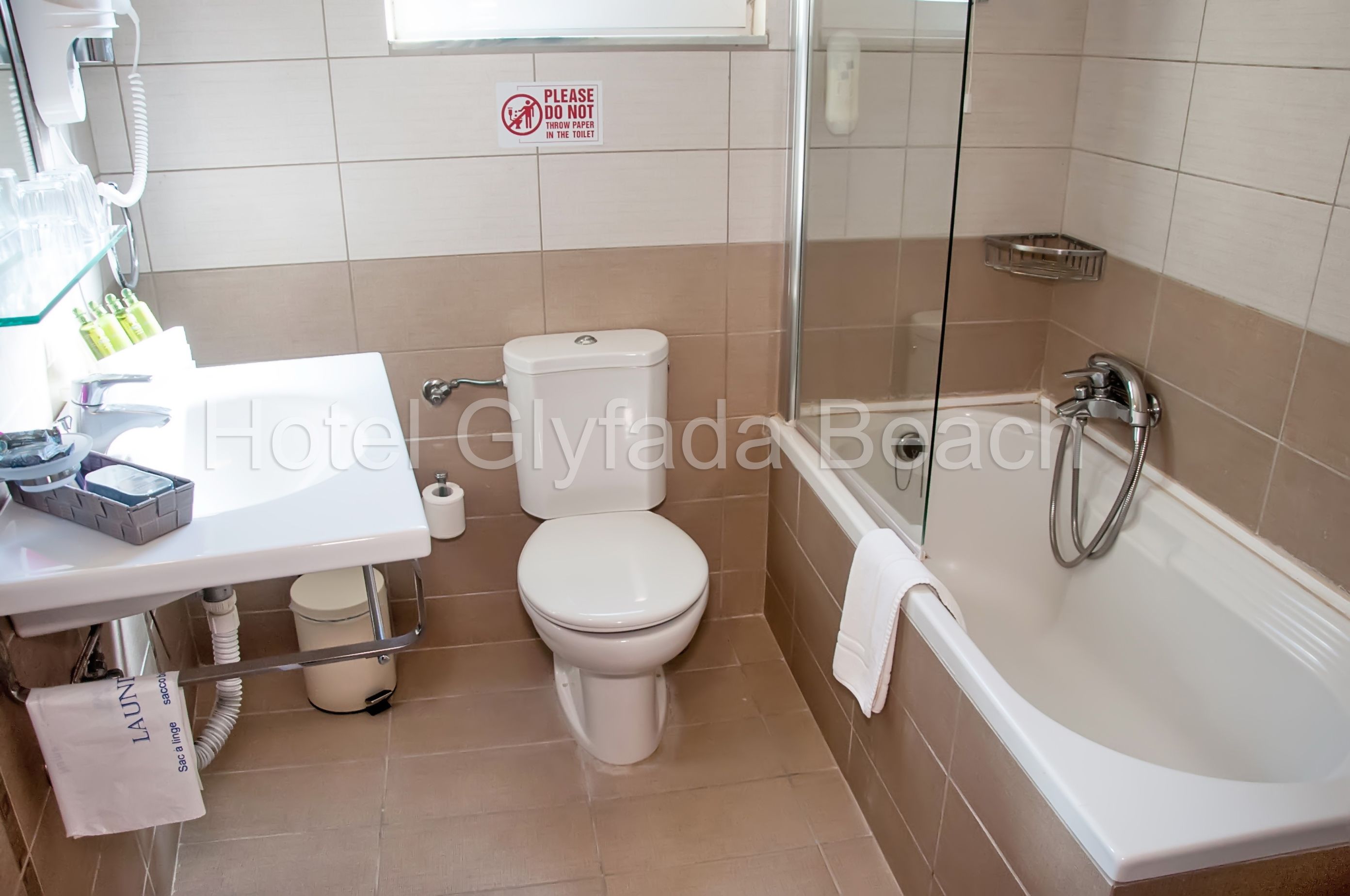 A bathroom with a toilet, sink, and bathtub.