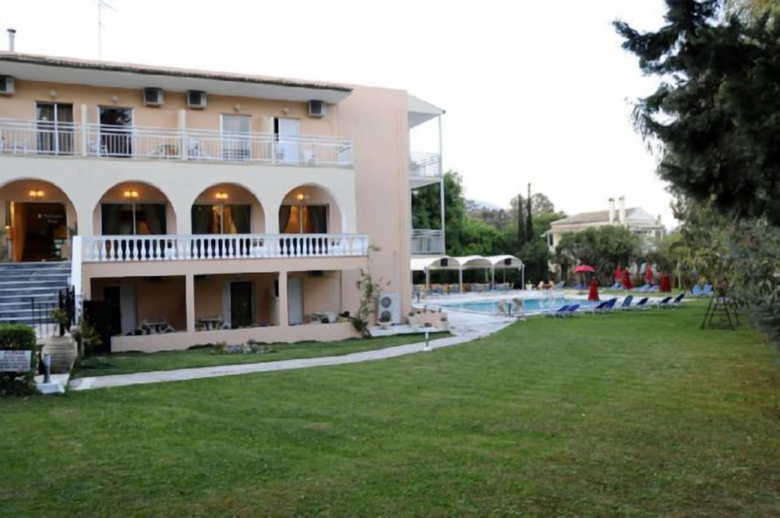 A building with a pool area, outdoor seating, and a covered patio.