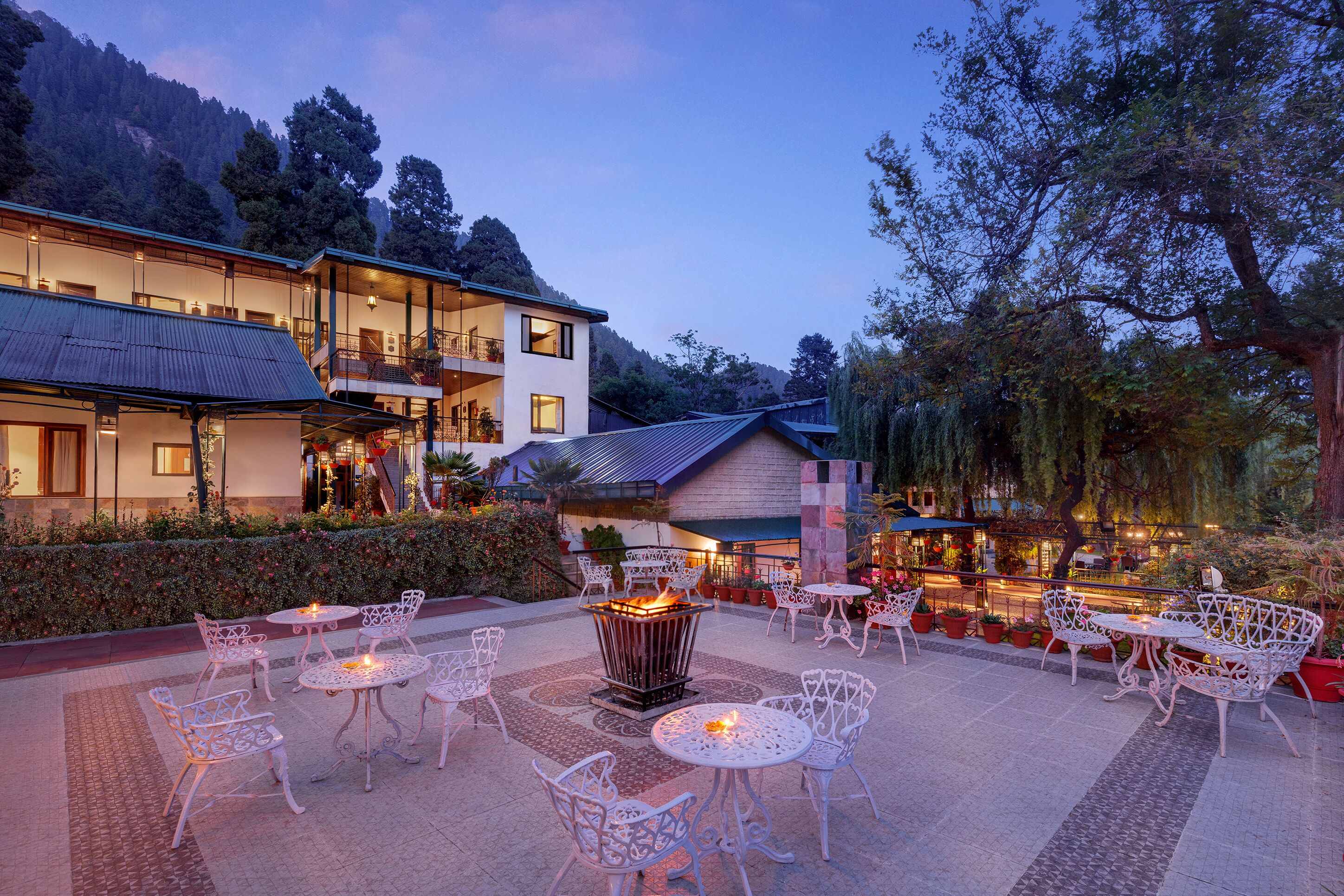 A hotel with outdoor seating and a fire pit.