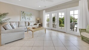 A spacious living room with a sofa, coffee table, and a ceiling fan. - Coral Lagoon Resort Villas & Marina by KeysCaribbean (Marathon)