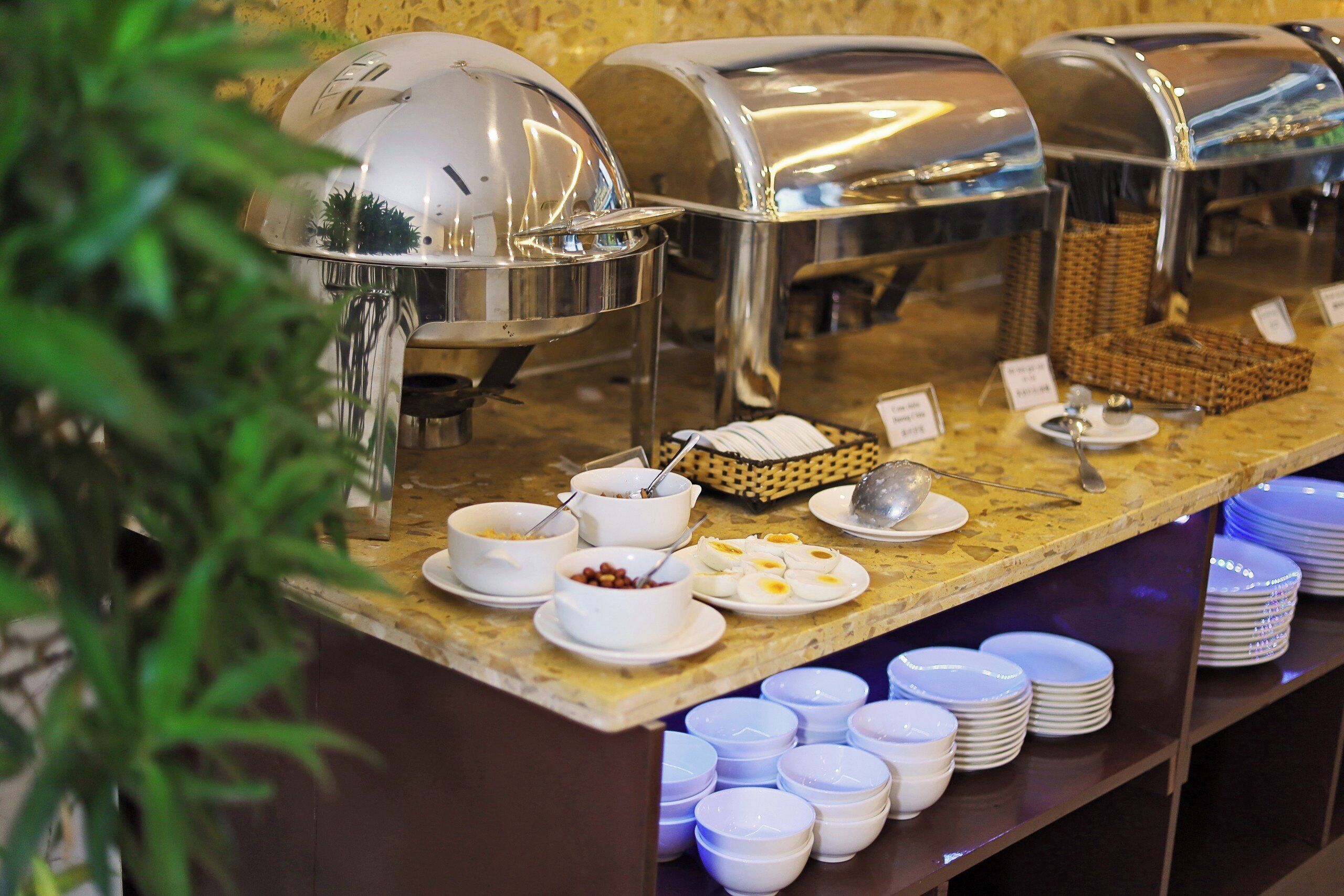 A buffet setup with multiple food stations and a variety of dishes.