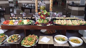 A buffet with various dishes including salads, sandwiches, and dips. - Presidential Hotel (Port Harcourt)