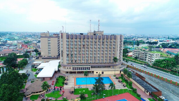 A large hotel with multiple floors, a swimming pool, and a parking area. - Presidential Hotel (Port Harcourt)