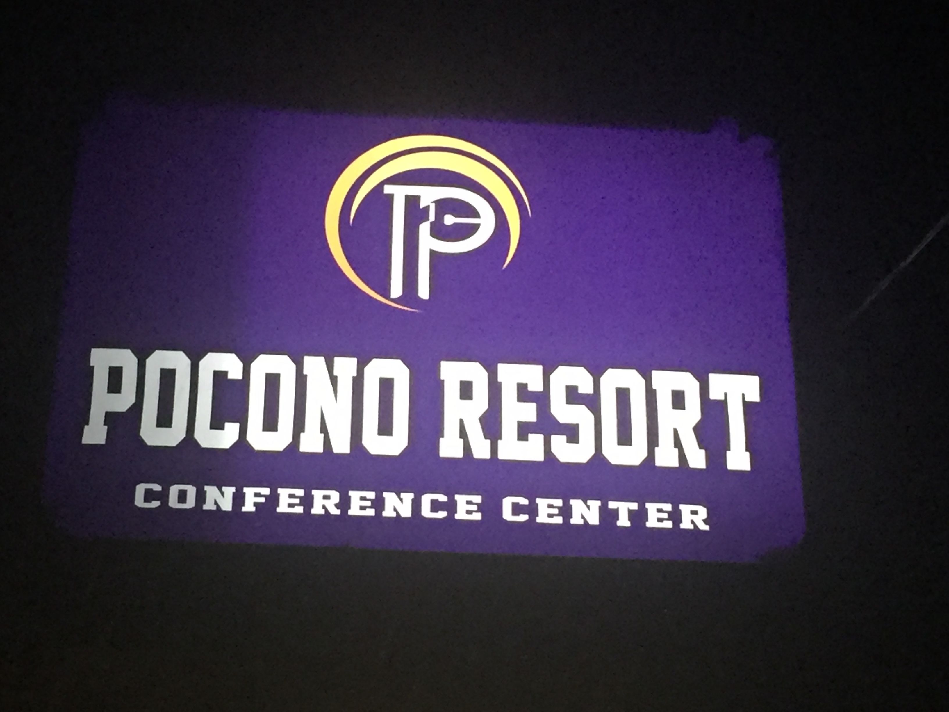 A sign for Pocono Resort Conference Center with a logo and text.