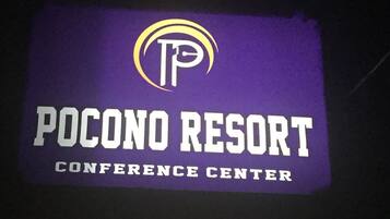 A sign for Pocono Resort Conference Center with a logo and text.