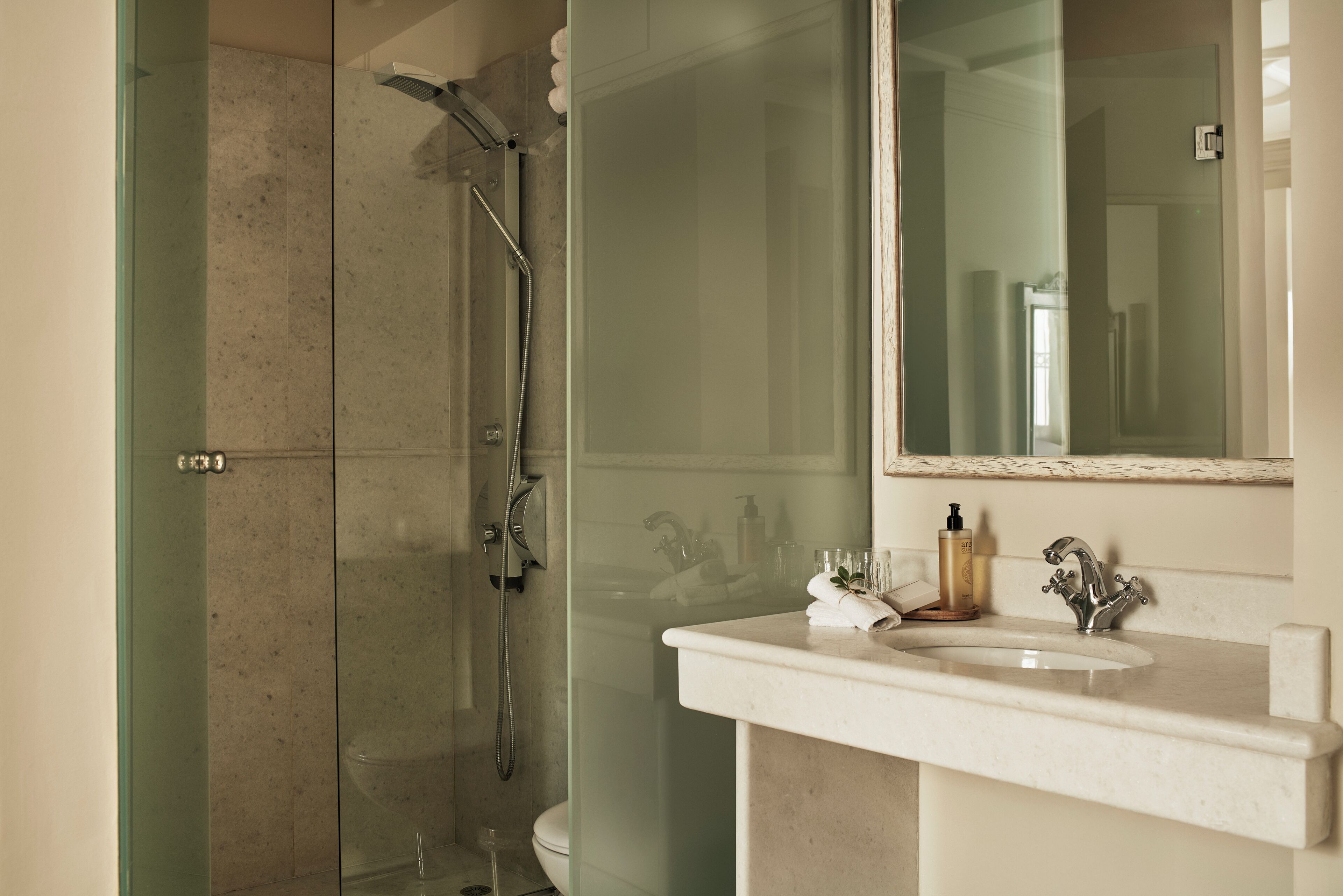 syrou melathron two bedroom sea view suite (main building) | bathroom | shower, free toiletries, hair dryer, slippers