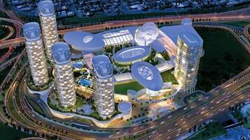 Een moderne stedelijke ontwikkeling met hoge gebouwen, onderling verbonden wegen en groene zones.