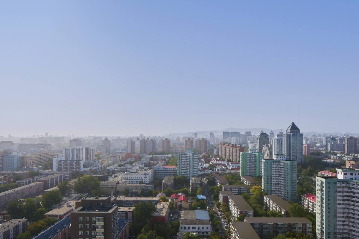 A cityscape with various buildings, including high-rise apartments and commercial structures.