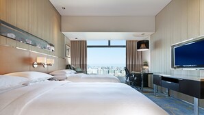 A hotel room with two beds, a desk, a TV, and a city view. - Sheraton Grand Beijing Dongcheng Hotel (Beijing)