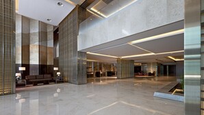 A spacious lobby with a polished floor, seating areas, and modern lighting fixtures. - Sheraton Grand Beijing Dongcheng Hotel (Beijing)