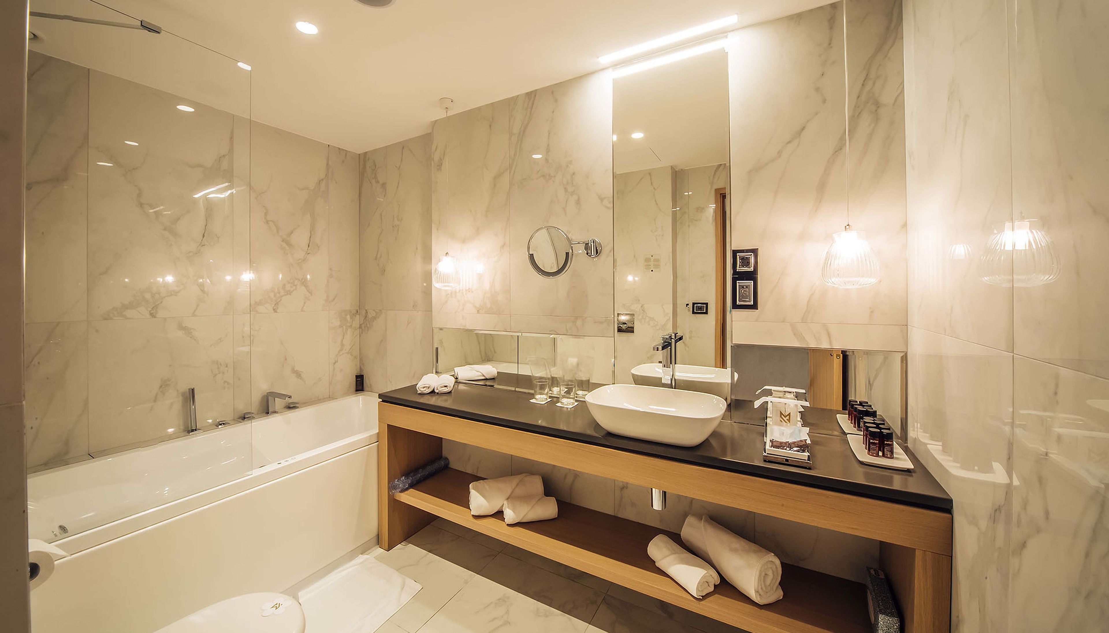 deluxe suite | bathroom | rainfall showerhead, free toiletries, hair dryer, bathrobes