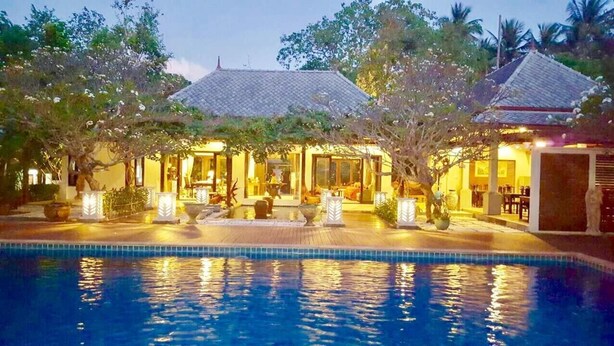 A resort with a swimming pool, traditional architecture, and well-lit outdoor areas. - Bhumlapa Garden Resort (Koh Samui)
