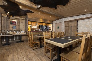 Enjoy a casual dining experience in this cozy space with a rustic wooden table and chalkboard menu.