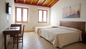 A bedroom with two beds, a desk, and a chair. There are two windows and a painting on the wall. - Corte Pontigliardo (Lazise)