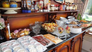 A breakfast buffet with various food items and condiments.