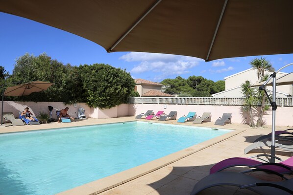 Outdoor pool, open 8:00 AM to 8:00 PM, pool umbrellas, sun loungers
