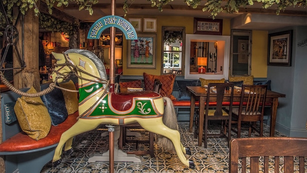 A carousel horse with a sign that reads "PLEASE DON'T MOUNT WITHIN 10 feet." - The Winning Post (Windsor)