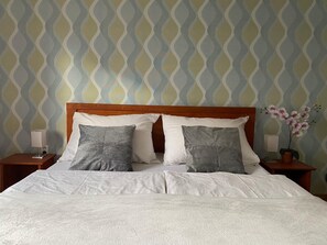 Chambre double ou avec lits jumeaux | Lit avec matelas à plateau-coussin, bureau, fer et planche à repasser