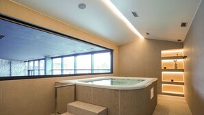 A modern bathroom with a hot tub, a window, and a set of stairs. - Degenija Boutique Hotel & Spa (Rakovica)