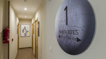 A hallway with a circular sign indicating room numbers 101-103 and 104-108.