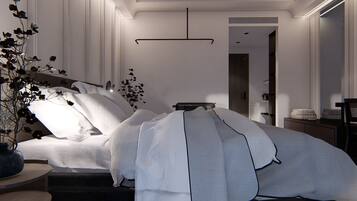 A modern bedroom with a large bed, a bedside table, a nightstand, a mirror, and a hanging light fixture.