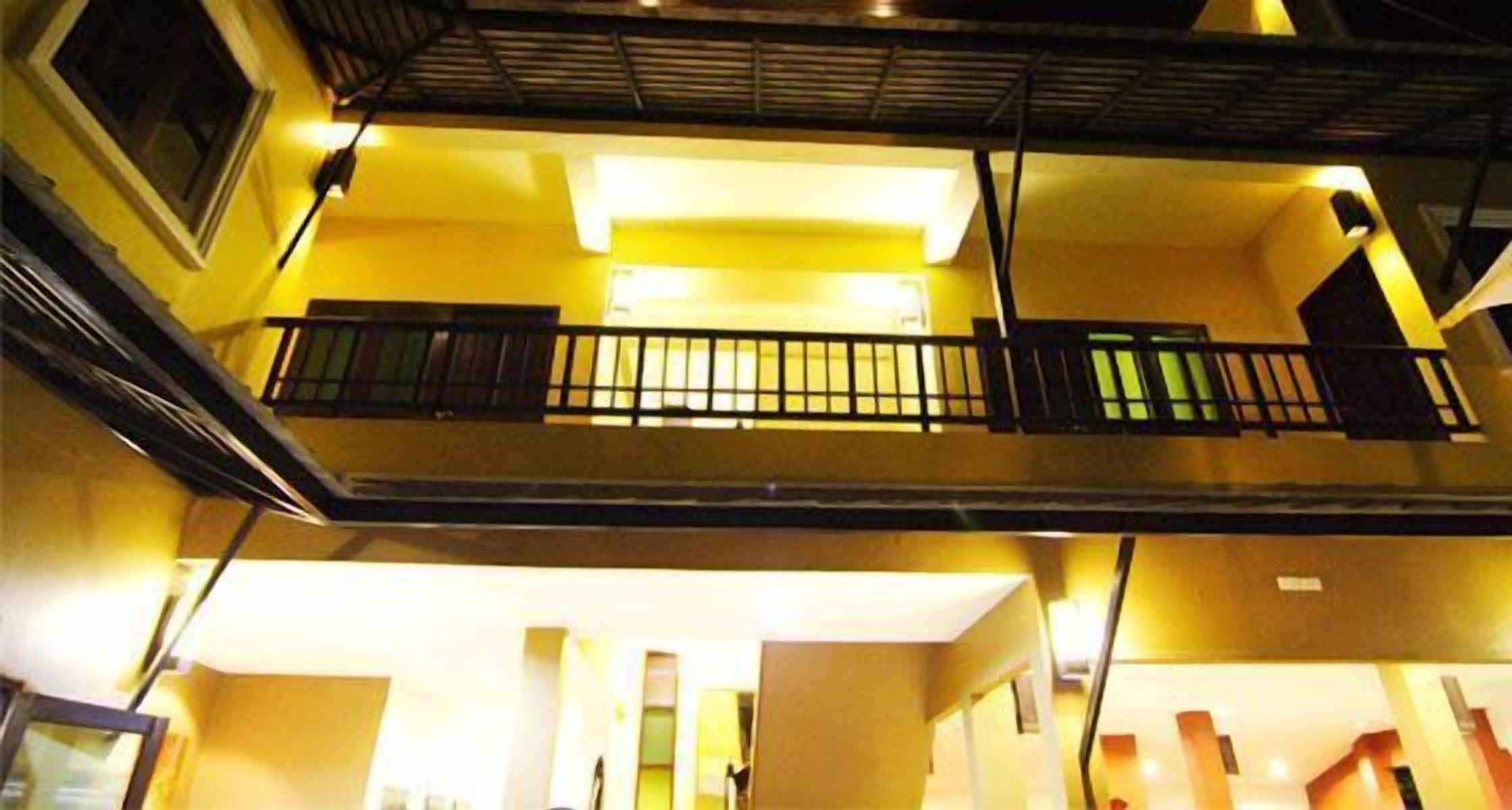 A multi-level building with a balcony on the upper floor.