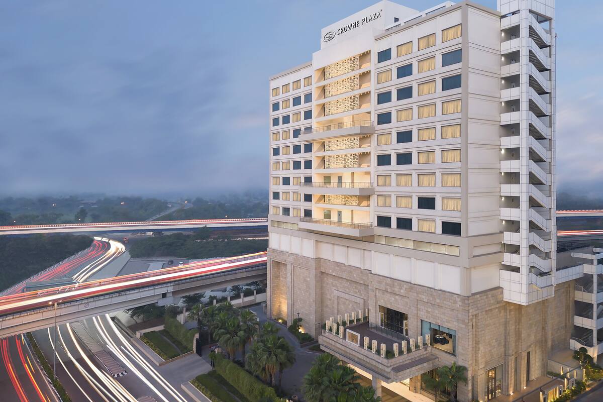 Een modern hotel met meerdere verdiepingen, een opvallende ingang en uitzicht op omliggende wegen.