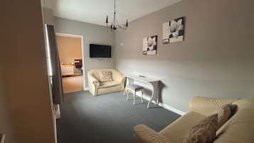 Family Quadruple Room | Living area | Flat-screen TV, DVD player