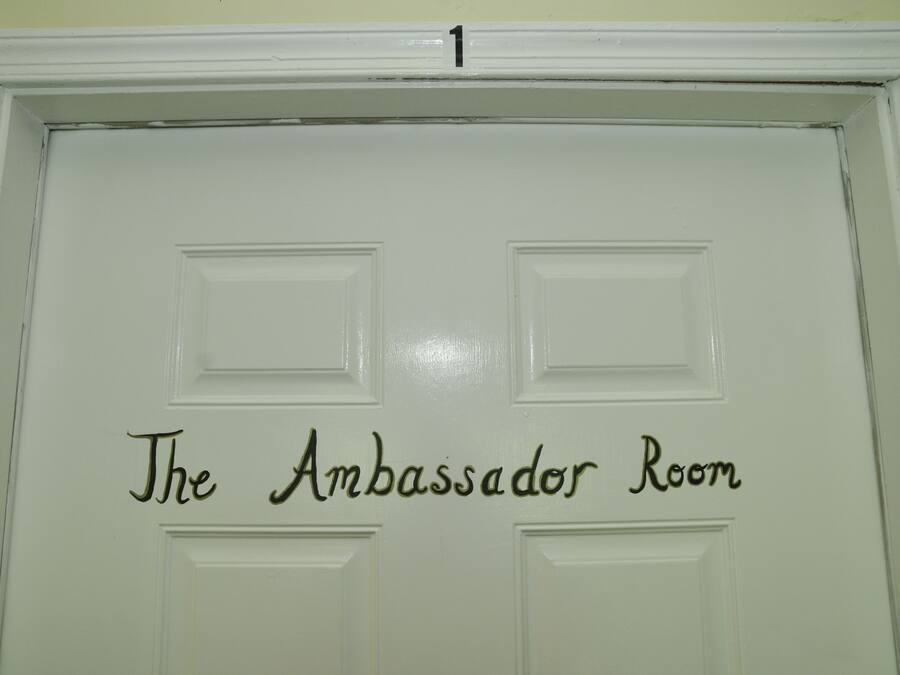 A door with the text "The Ambassador Room" and a number "1" above it.
