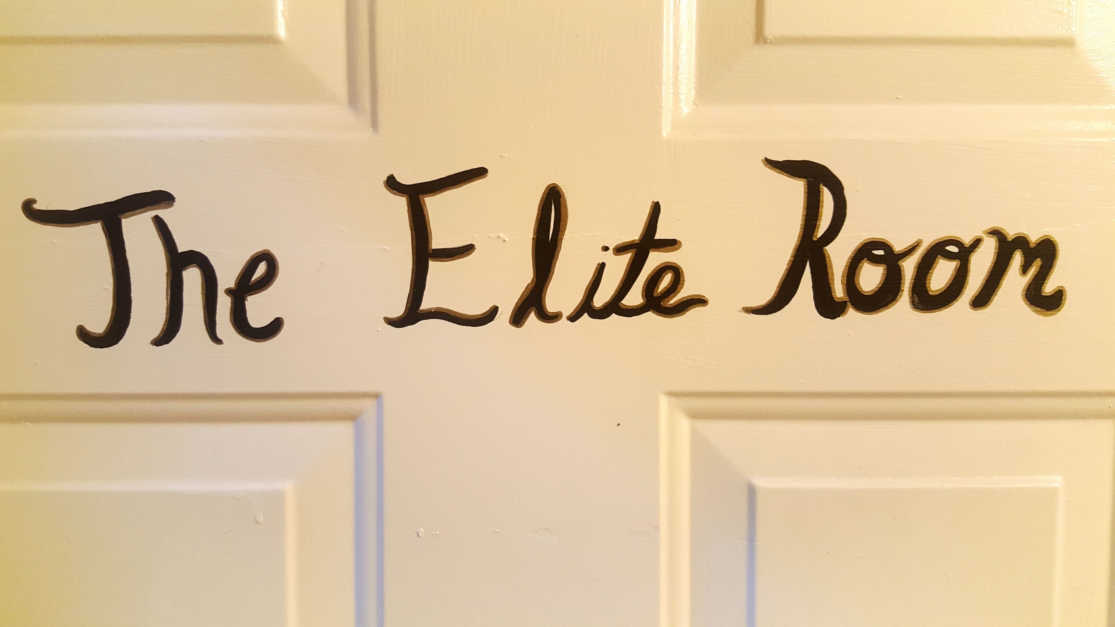 A door with the text "The Elite Room" written on it.