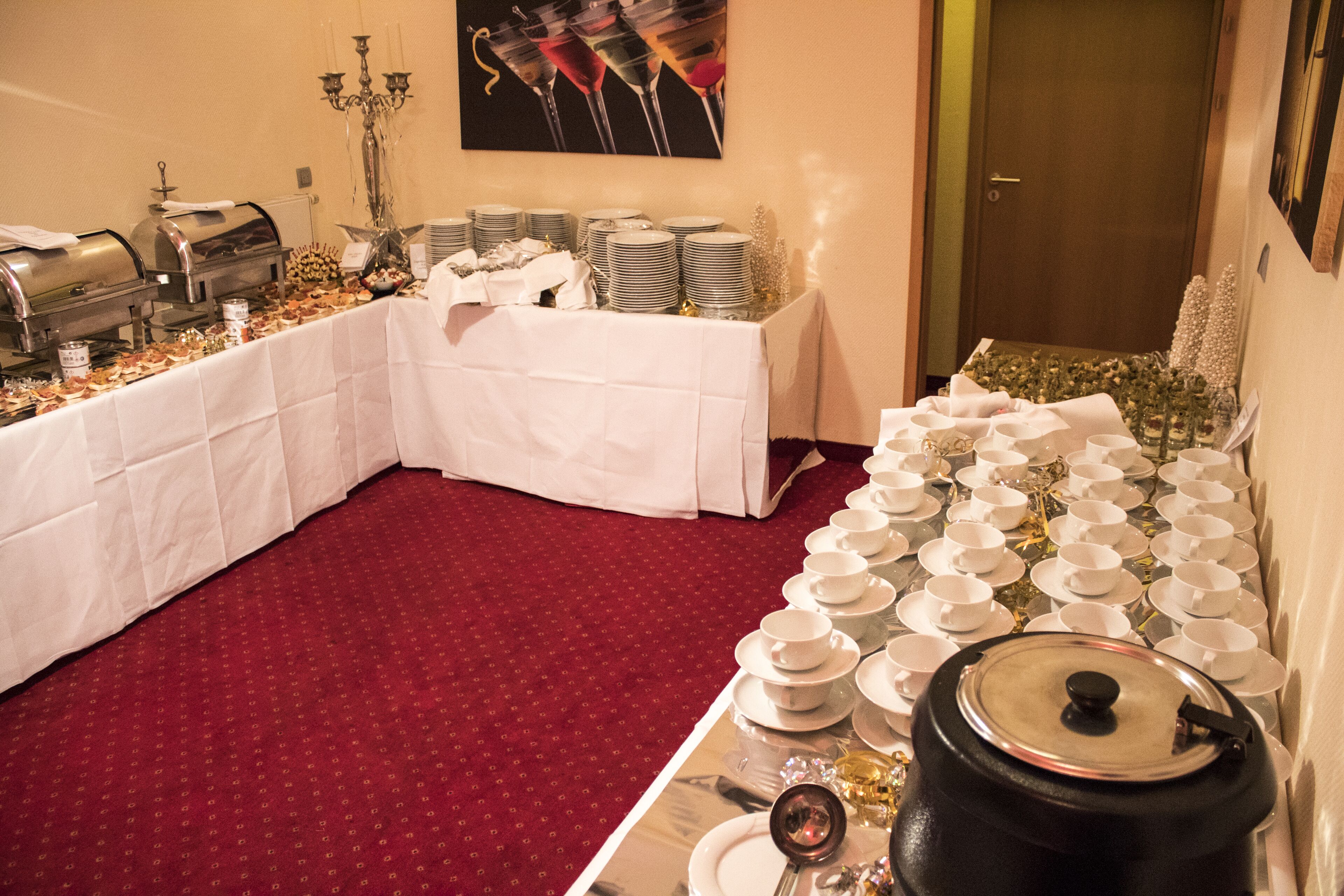 A buffet setup with multiple serving stations, a variety of dishes, and a decorative candelabra.
