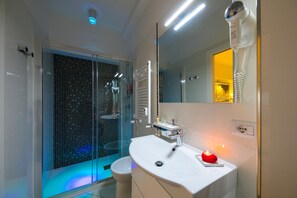 Shower, designer toiletries, hair dryer, slippers