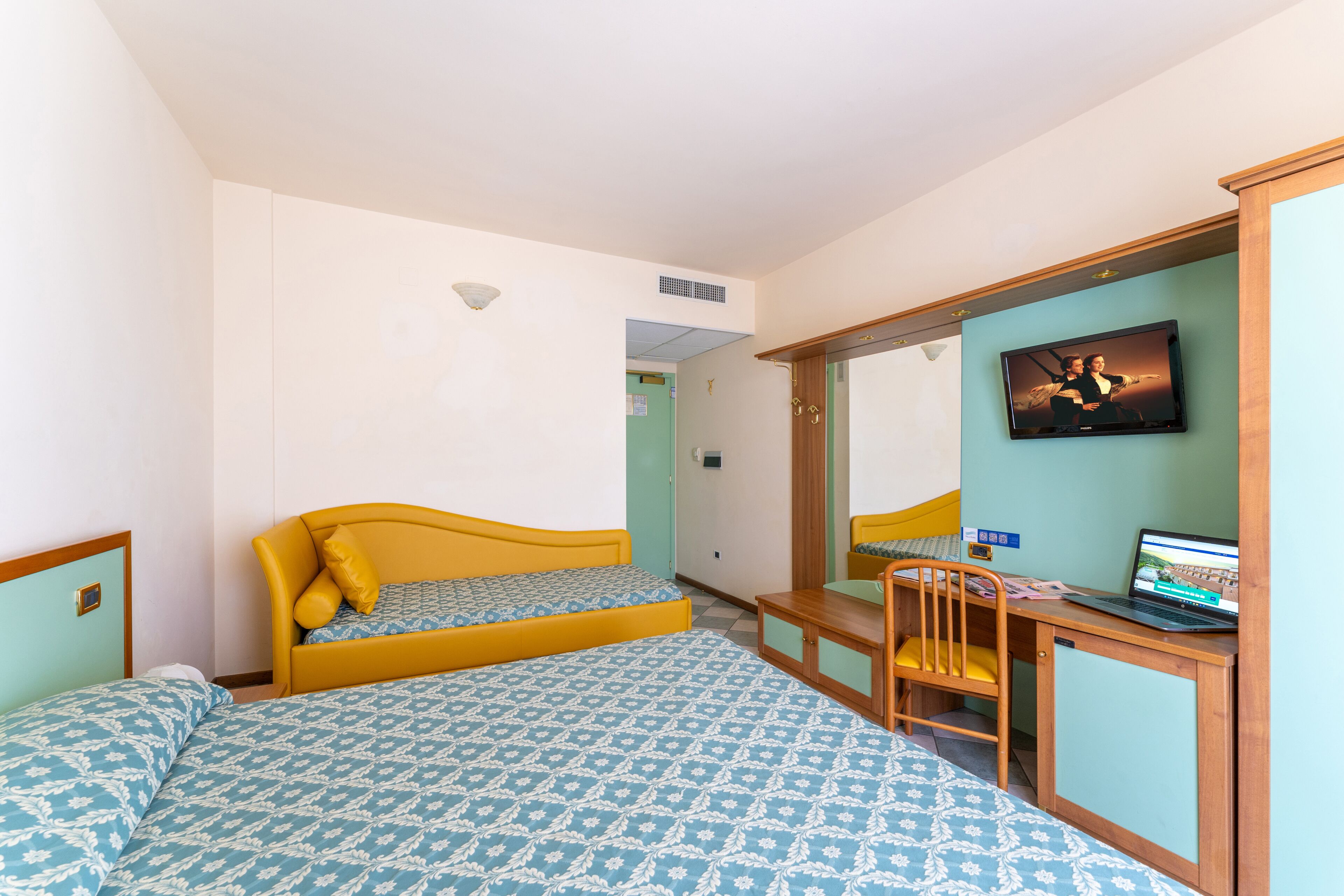 Comfort Triple Room | Minibar, in-room safe, desk, blackout drapes
