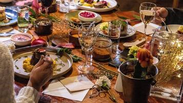 A dining table with various dishes, glasses, and a potted plant.