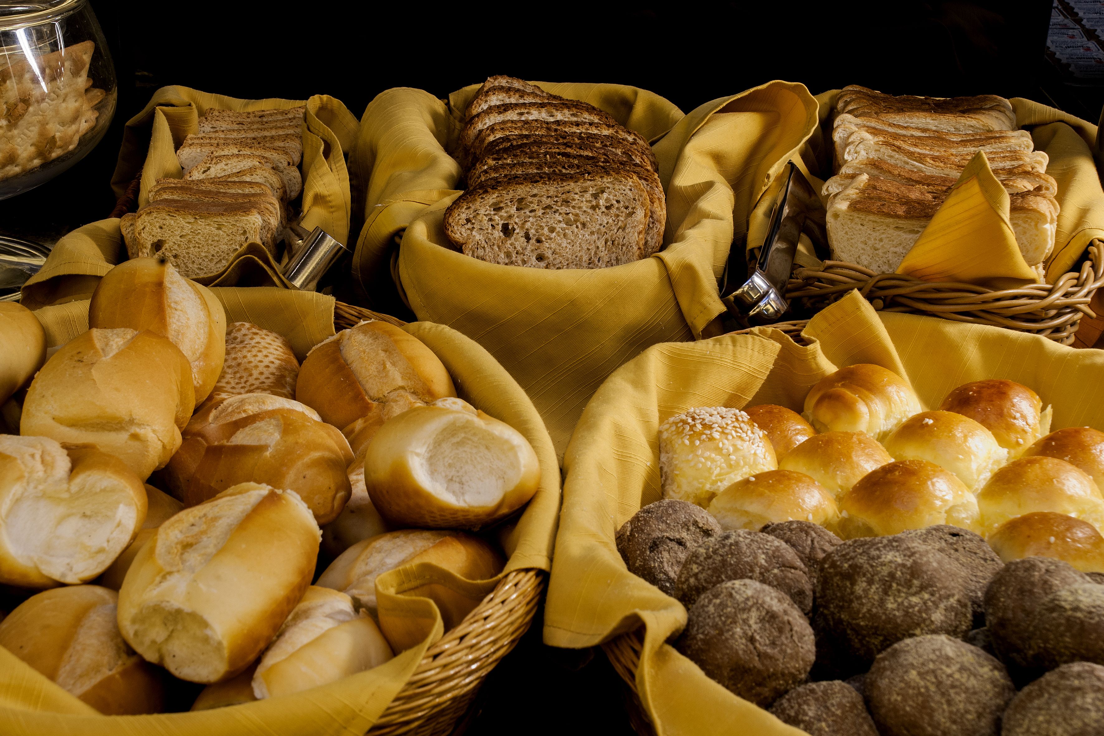 A variety of breads and pastries displayed in baskets.