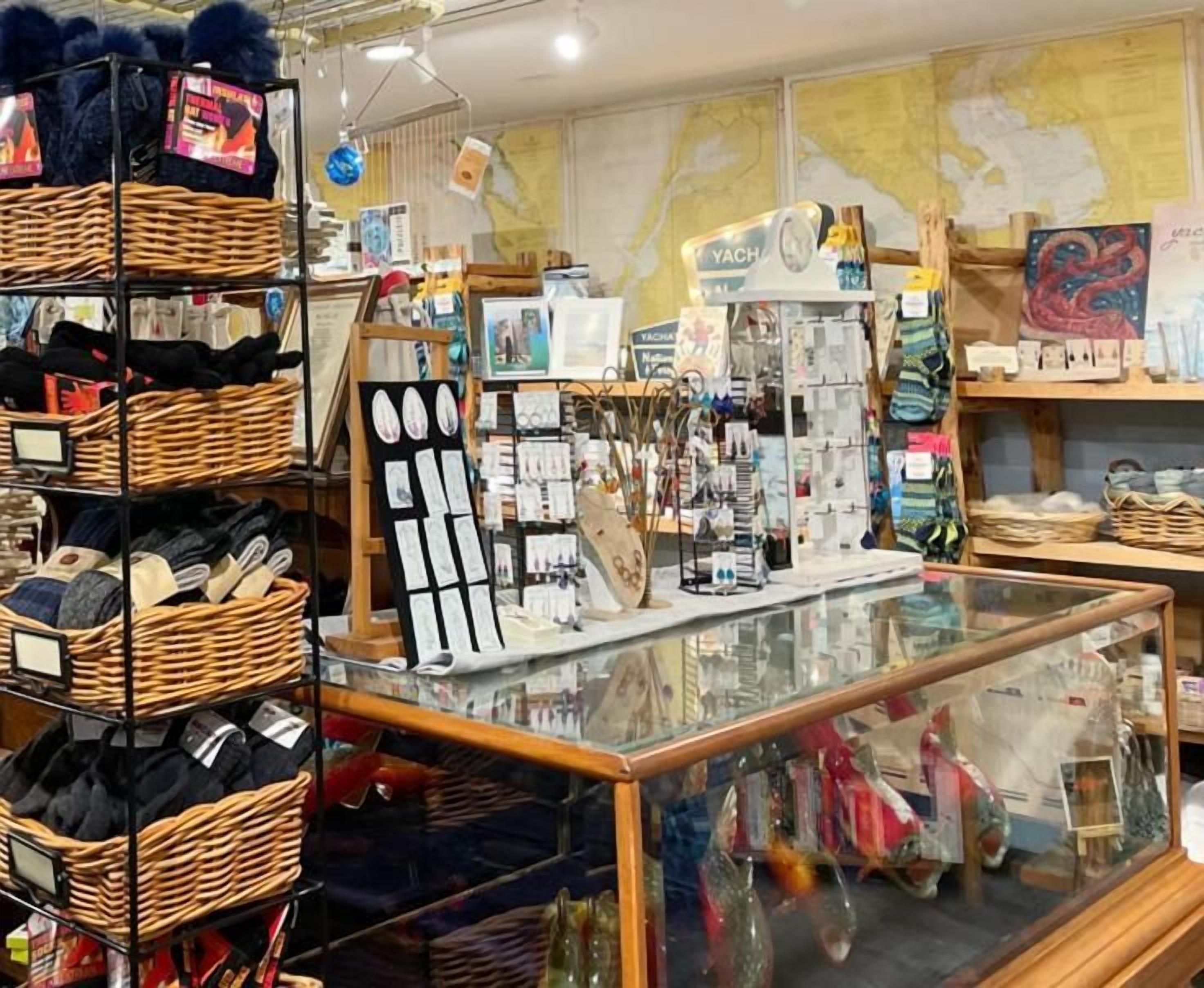 A retail store with shelves of shoes, a display of jewelry, and various items on sale.