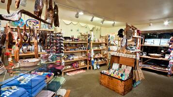 A store with wooden shelves, hanging items, and various products.