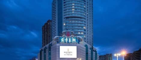A tall hotel with a prominent sign for the "Hotel 10" and "Dongfang Hotel" in the center.