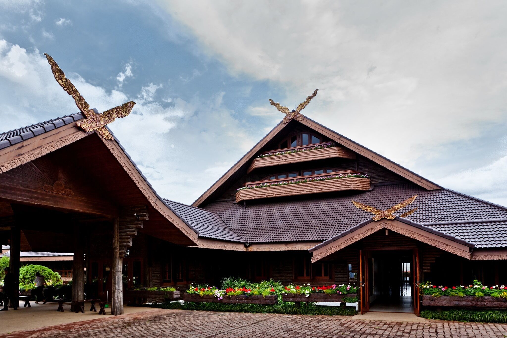 A traditional wooden building with a sloped roof and ornate decorations.
