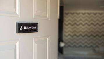 A door with a sign reading "SLEEPOVER (3)".